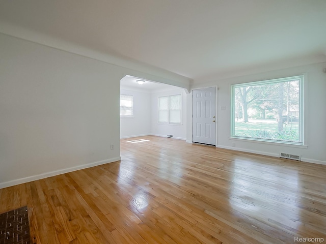 23740 Lee Baker Dr, Southfield, MI 48075 - unfurnished living room with arched walkways and light wood finished floors