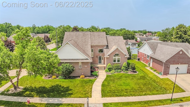 15980 Monterey St, Southgate, MI 48195 - view of front of home with brick siding, a front yard, driveway, and a residential view