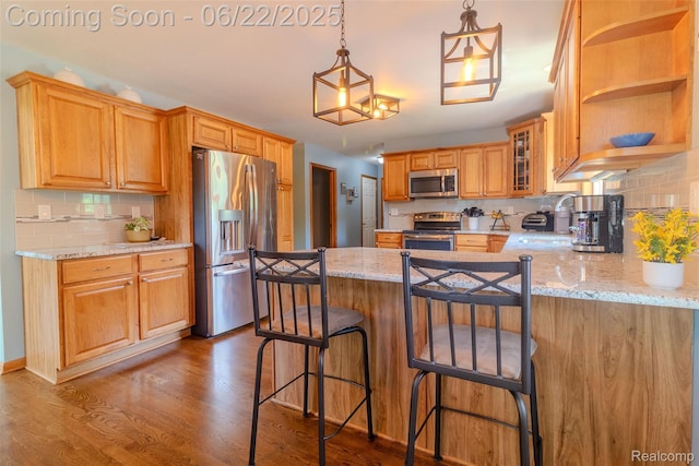 15980 Monterey St, Southgate, MI 48195 - kitchen with stainless steel appliances, backsplash, a peninsula, wood finished floors, and glass insert cabinets