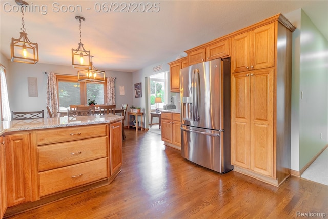 15980 Monterey St, Southgate, MI 48195 - kitchen with stainless steel fridge with ice dispenser, wood finished floors, and healthy amount of natural light
