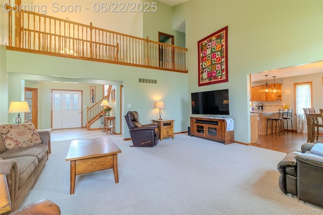 15980 Monterey St, Southgate, MI 48195 - living room with a high ceiling, stairway, and carpet floors