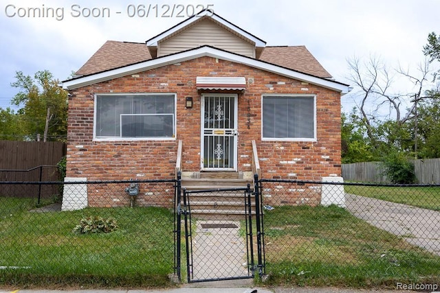 15834 Baylis St, Detroit, MI 48238 - view of front of home with a gate, brick siding, roof with shingles, and a fenced front yard
