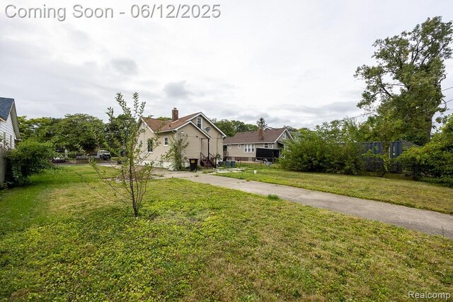15834 Baylis St, Detroit, MI 48238 - view of front of home featuring a front lawn and concrete driveway
