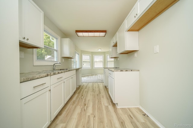 4865 Huston Dr, Lake Orion, MI 48359 - kitchen featuring light wood-style flooring, white cabinets, and light stone counters