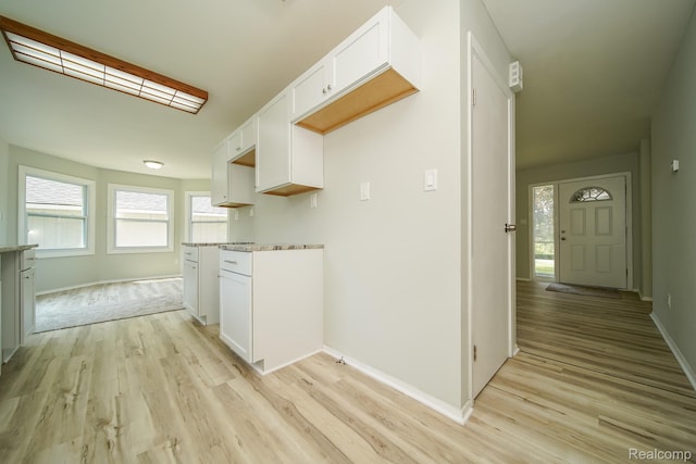 4865 Huston Dr, Lake Orion, MI 48359 - kitchen featuring light wood-type flooring and white cabinetry