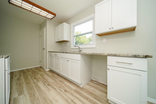 4865 Huston Dr, Lake Orion, MI 48359 - kitchen featuring light wood finished floors, white cabinetry, and light stone counters