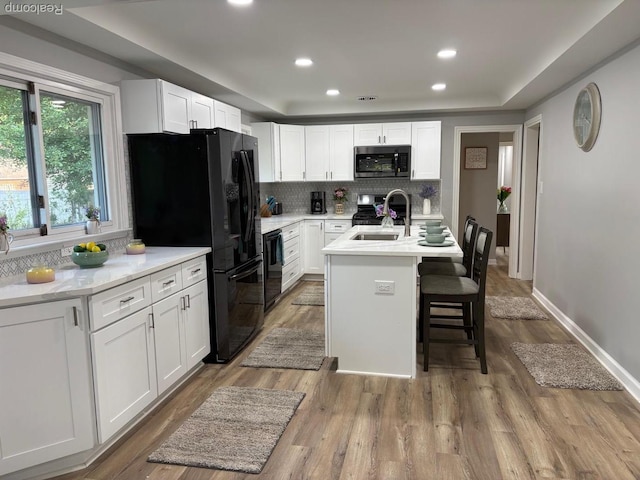 2211 Parkside St, Trenton, MI 48183 - kitchen with black appliances, tasteful backsplash, light countertops, white cabinetry, and recessed lighting