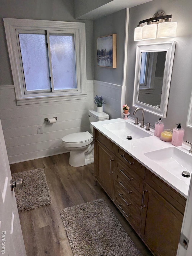2211 Parkside St, Trenton, MI 48183 - bathroom with wood finished floors, double vanity, and wainscoting