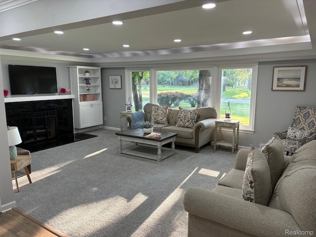 2211 Parkside St, Trenton, MI 48183 - carpeted living area featuring healthy amount of natural light, a fireplace with flush hearth, a raised ceiling, and recessed lighting