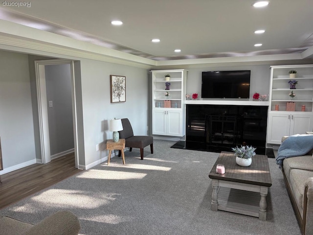 2211 Parkside St, Trenton, MI 48183 - carpeted living room with a raised ceiling, recessed lighting, wood finished floors, and a fireplace with flush hearth