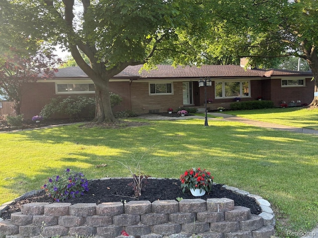 2211 Parkside St, Trenton, MI 48183 - ranch-style home featuring a front yard, brick siding, and a chimney