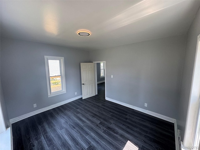 1112 Brockway Rd, Saginaw, MI 48602 - spare room featuring baseboards and dark wood-style floors