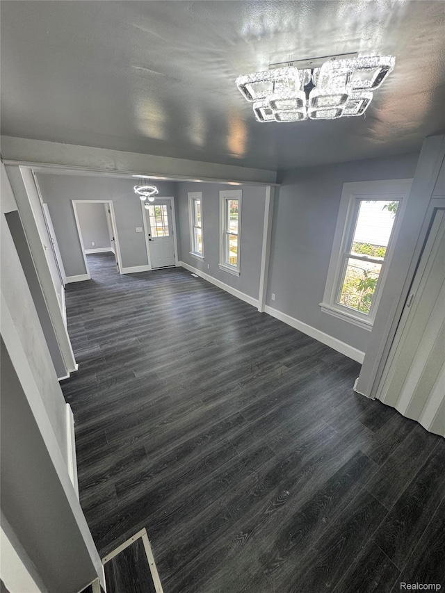 1112 Brockway Rd, Saginaw, MI 48602 - unfurnished living room with a chandelier and dark wood-style flooring