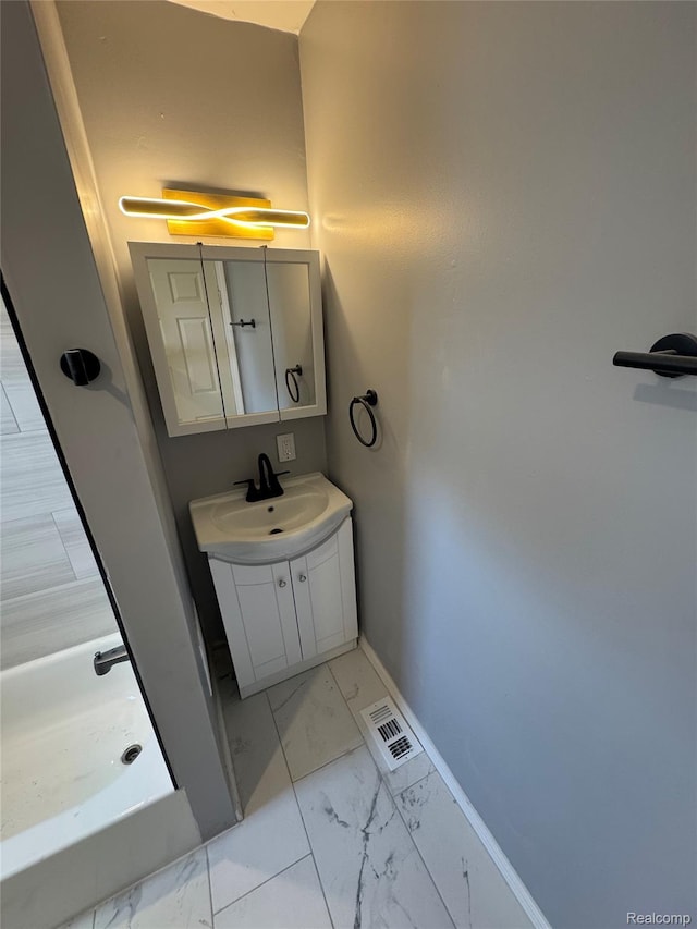 1112 Brockway Rd, Saginaw, MI 48602 - bathroom featuring marble look tile flooring, vanity, and a shower