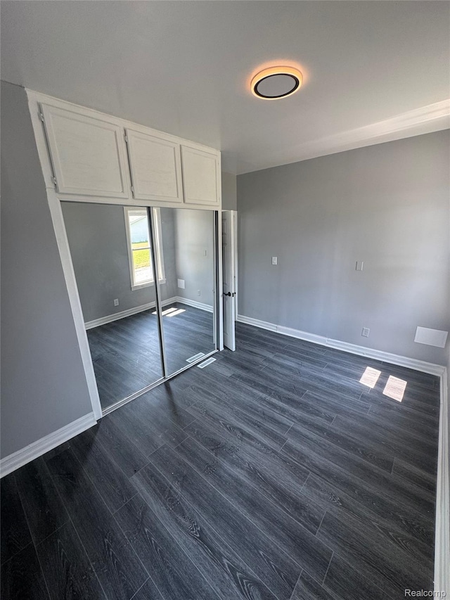 1112 Brockway Rd, Saginaw, MI 48602 - unfurnished bedroom featuring dark wood finished floors and a closet