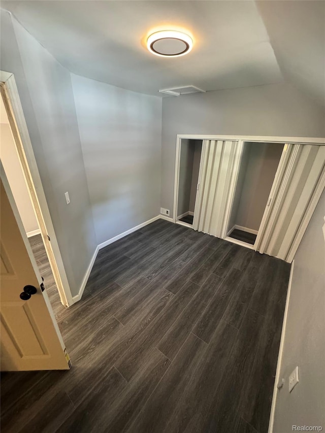 1112 Brockway Rd, Saginaw, MI 48602 - unfurnished bedroom with dark wood finished floors, lofted ceiling, and a closet