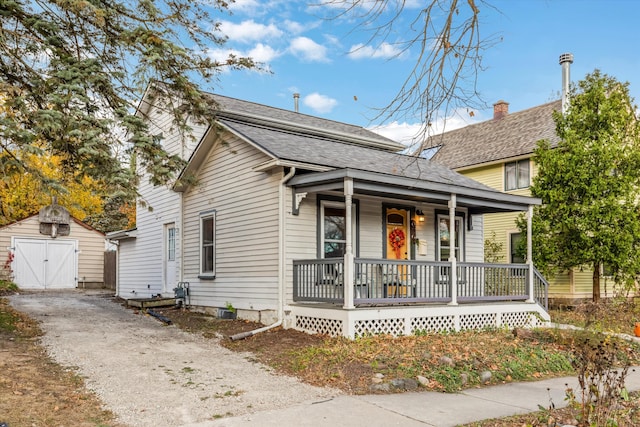 626 Hiscock St, Ann Arbor, MI 48103 - view of front of property featuring a porch, an outdoor structure, and roof with shingles
