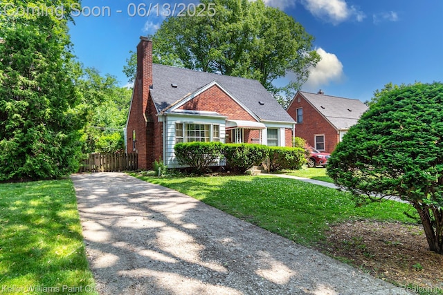 526 W Webster Rd, Royal Oak, MI 48073 - view of front of property with brick siding, a chimney, and driveway