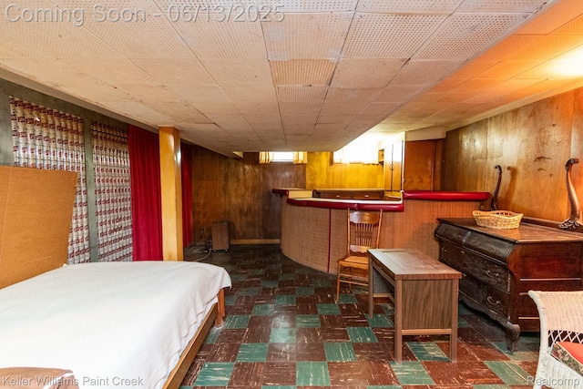 526 W Webster Rd, Royal Oak, MI 48073 - bedroom with tile patterned floors, wood walls, and a bar
