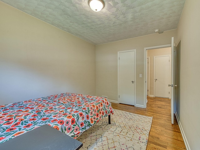 219 Park St, Tecumseh, MI 49286 - bedroom with light wood finished floors and a textured ceiling
