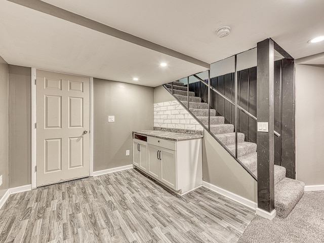 219 Park St, Tecumseh, MI 49286 - finished below grade area featuring stairway, light wood-style floors, and recessed lighting