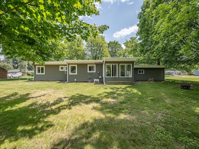 219 Park St, Tecumseh, MI 49286 - rear view of property featuring a lawn