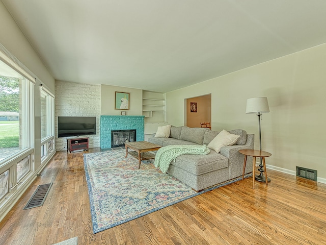 219 Park St, Tecumseh, MI 49286 - living room featuring wood finished floors and a fireplace