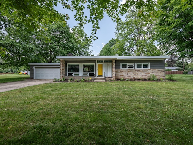 219 Park St, Tecumseh, MI 49286 - mid-century home featuring a garage, stone siding, concrete driveway, a chimney, and entry steps