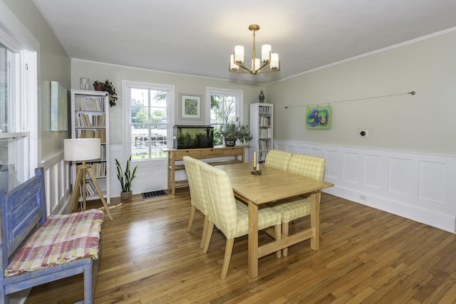 3444 Broad St, Dexter, MI 48130 - dining room with a chandelier, wood finished floors, wainscoting, ornamental molding, and a decorative wall