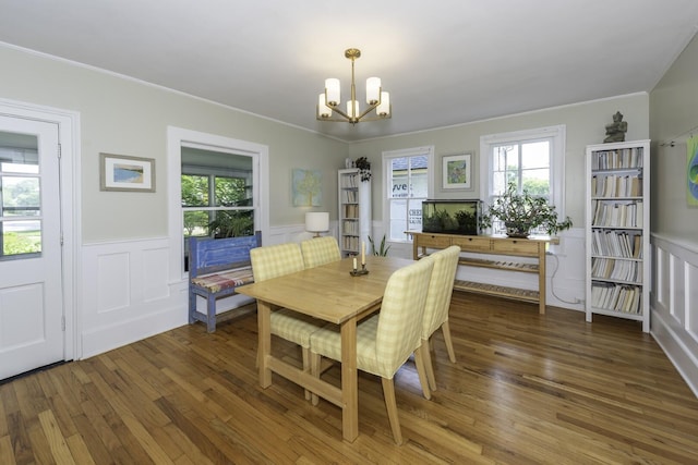 3444 Broad St, Dexter, MI 48130 - dining area featuring a chandelier, wood finished floors, crown molding, wainscoting, and a decorative wall