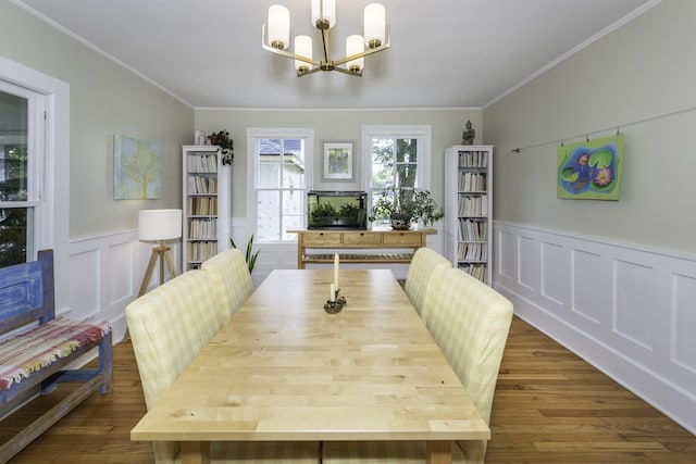 3444 Broad St, Dexter, MI 48130 - dining area with crown molding, a chandelier, wood finished floors, a wainscoted wall, and a decorative wall