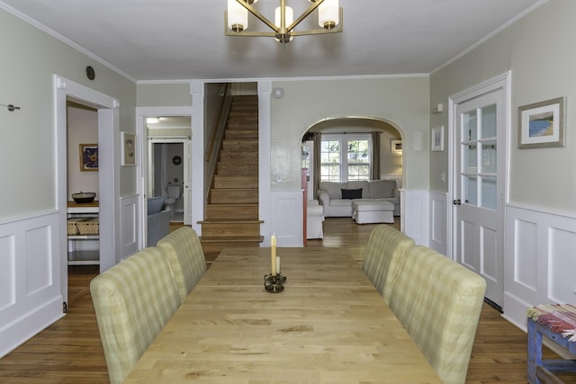 3444 Broad St, Dexter, MI 48130 - dining room with arched walkways, a chandelier, crown molding, a decorative wall, and stairs