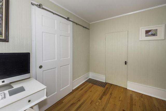 3444 Broad St, Dexter, MI 48130 - unfurnished bedroom with crown molding, a barn door, and wood finished floors