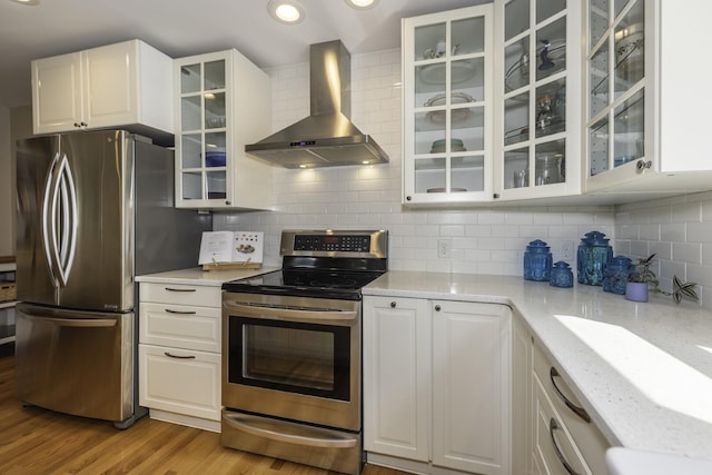 3444 Broad St, Dexter, MI 48130 - kitchen with wall chimney exhaust hood, stainless steel appliances, light wood finished floors, white cabinetry, and glass insert cabinets