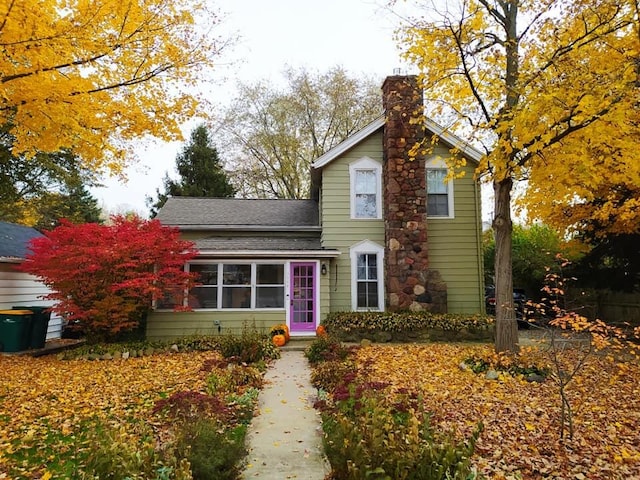 3444 Broad St, Dexter, MI 48130 - traditional home featuring a chimney and roof with shingles