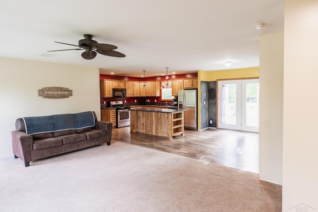 4100 Maloney Rd, Pinconning, MI 48650 - living room featuring carpet flooring and ceiling fan