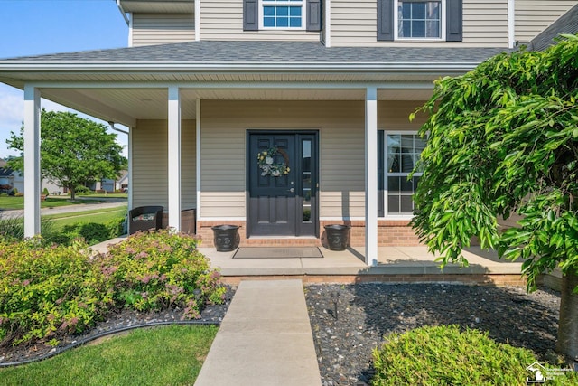 696 Webber Dr, Temperance, MI 48182 - property entrance with a porch, brick siding, and a shingled roof