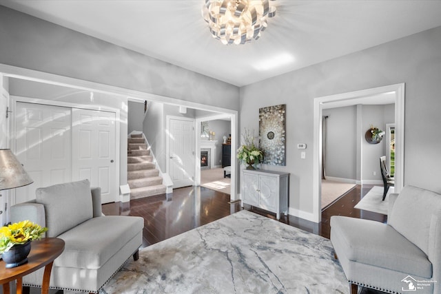 696 Webber Dr, Temperance, MI 48182 - living room featuring stairway, a warm lit fireplace, wood finished floors, and a chandelier