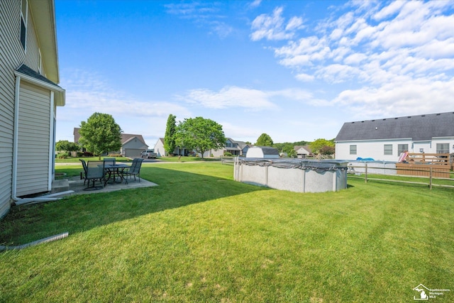696 Webber Dr, Temperance, MI 48182 - view of green lawn featuring a residential view, a covered pool, and a patio area