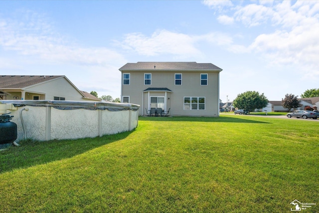 696 Webber Dr, Temperance, MI 48182 - back of house with a yard and a covered pool