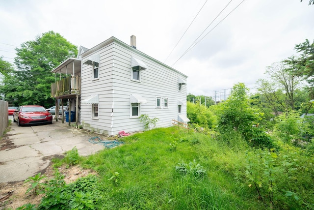 635 Sinclair Ave NE, Grand Rapids, MI 49503 - view of side of home featuring a chimney