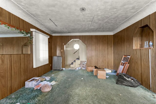 3966 12th St, Ecorse, MI 48229 - spare room with carpet floors, wooden walls, stairway, and radiator