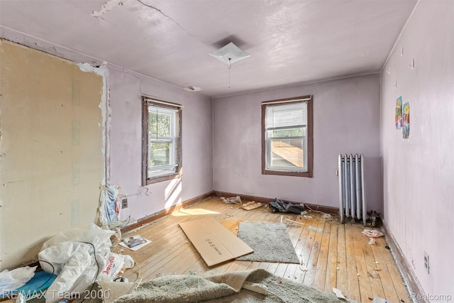 3966 12th St, Ecorse, MI 48229 - unfurnished room with radiator heating unit, plenty of natural light, and hardwood / wood-style flooring