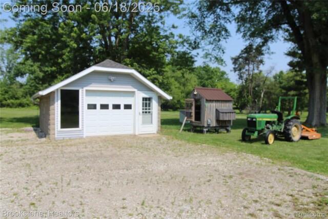 32599 Armada Ridge Rd, Richmond, MI 48062 - detached garage featuring driveway and view of scattered trees