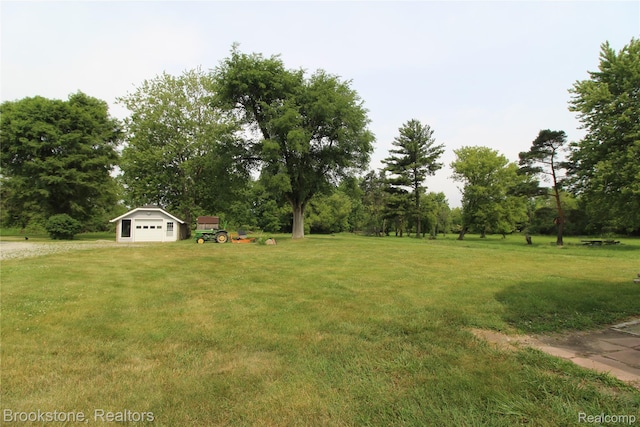 32599 Armada Ridge Rd, Richmond, MI 48062 - view of grassy yard with an outbuilding, view of wooded area, and a garage