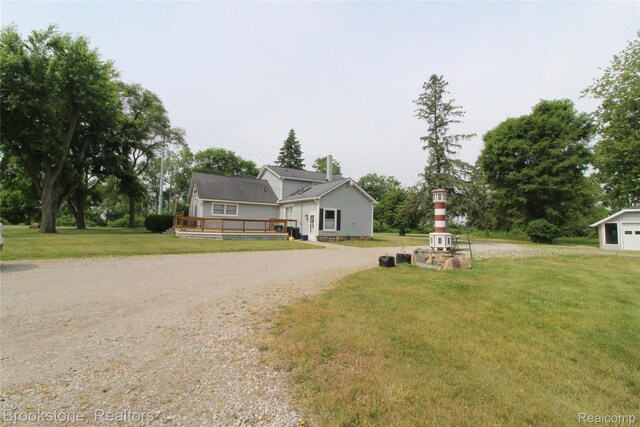 32599 Armada Ridge Rd, Richmond, MI 48062 - view of front facade featuring a deck, a front yard, and gravel driveway