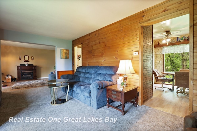 959 N Cass Ave, Vassar, MI 48768 - carpeted living area with a ceiling fan and wood walls