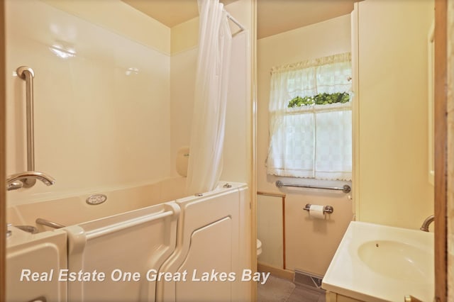 959 N Cass Ave, Vassar, MI 48768 - bathroom featuring vanity, shower / bath combo, and tile patterned flooring