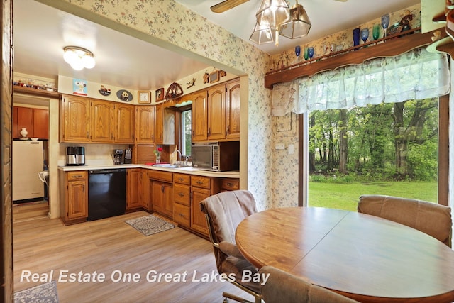 959 N Cass Ave, Vassar, MI 48768 - kitchen with black dishwasher, wallpapered walls, fridge, brown cabinetry, and light countertops
