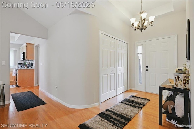 50064 Josephine Dr, Macomb, MI 48044 - foyer entrance featuring a chandelier, light wood-style floors, and high vaulted ceiling